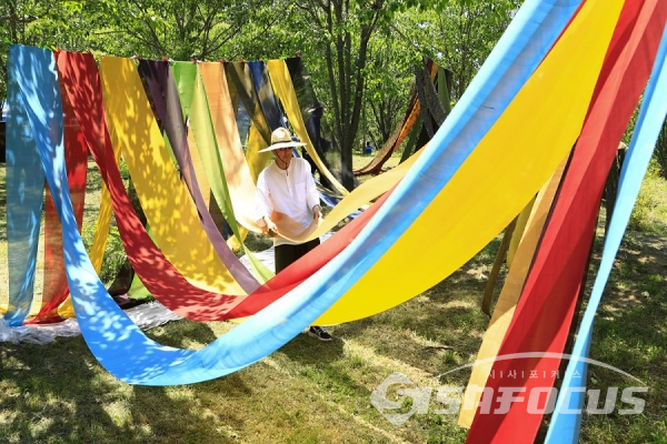 화려한 색감의 천연염색천을 선보이며 기량을 뽐내고 있다. 사진/강종민 기자