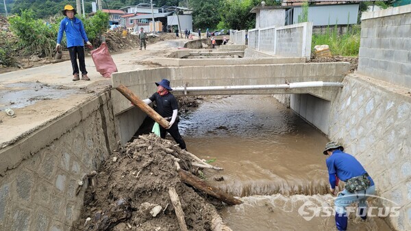 마을을 지나는 냇가는 물론 수로의 오물도 청소해 다음에 닥칠 호우도 준비할 수 있도록 수로에 떠내려온 쓰레기를 치우고 있다. 사진/김진성 기자