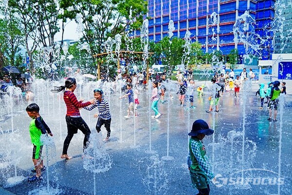 29일 오후 어린이들이 광화문광장 분수에서 나오는 시원한  물줄기를 맞으며 물놀이를 즐기고 있다. 사진/유우상 기자
