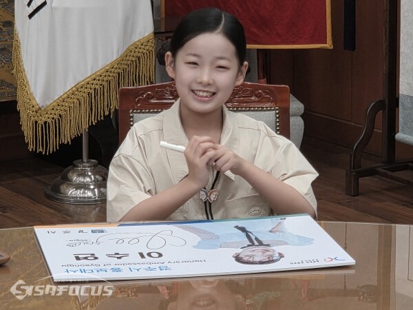 트롯가수 이수연 양이 직접 사인하는 모습. 사진 / 김인철 기자